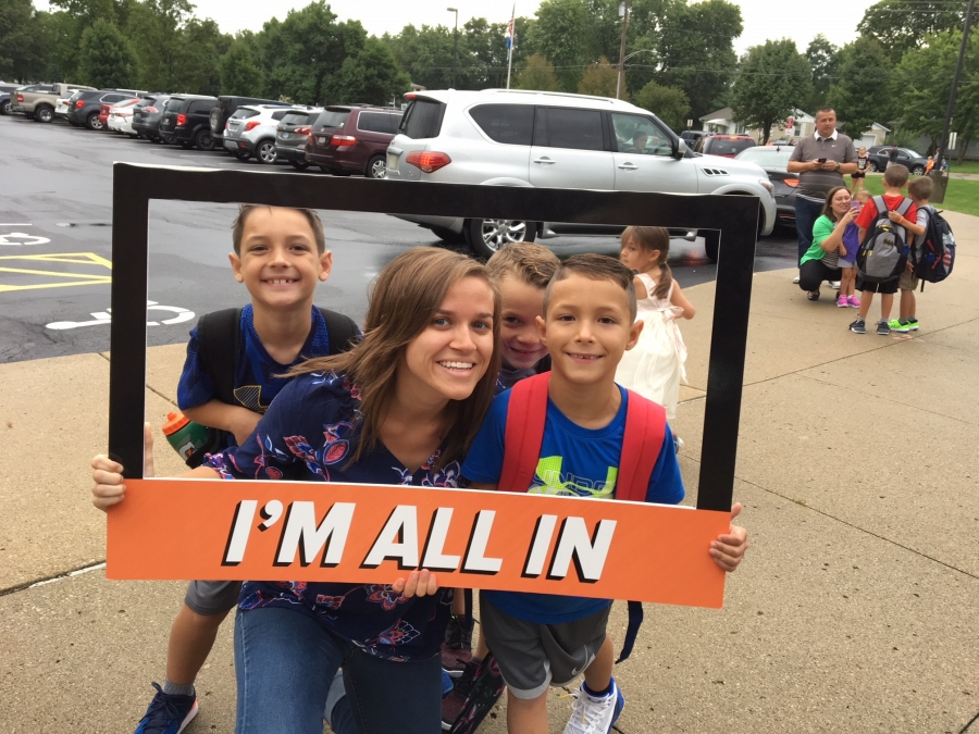 people holding a frame sign